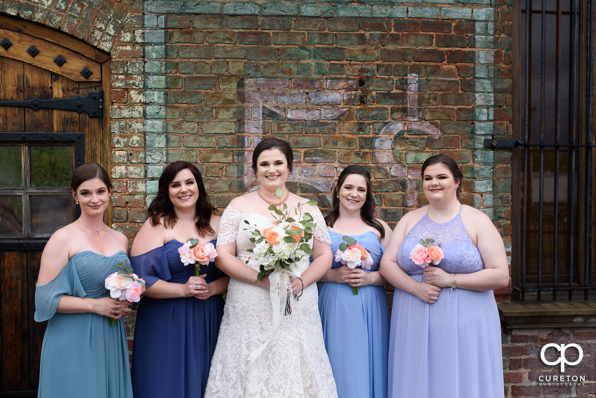 Bride and bridesmaids on the deck of The Old Cigar Warehouse.