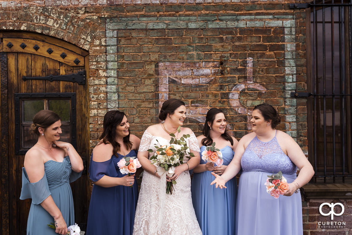 Bride having fun with her bridesmaids on the deck of The Old Cigar Warehouse.