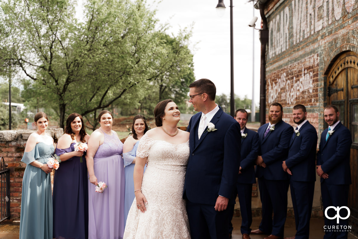 Bride and groom surrounded by her bridal party on the deck of The Old Cigar Warehouse.