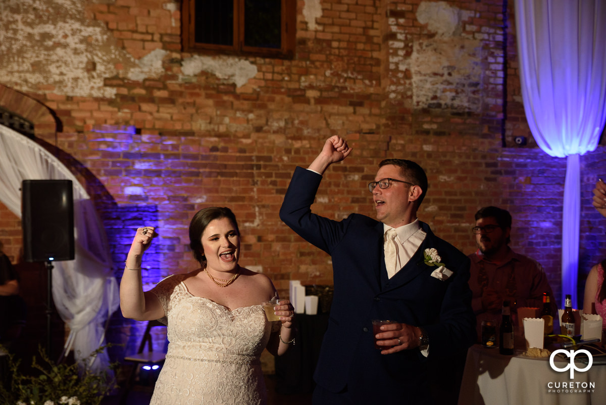 Bride and groom doing the Clemson cheer.