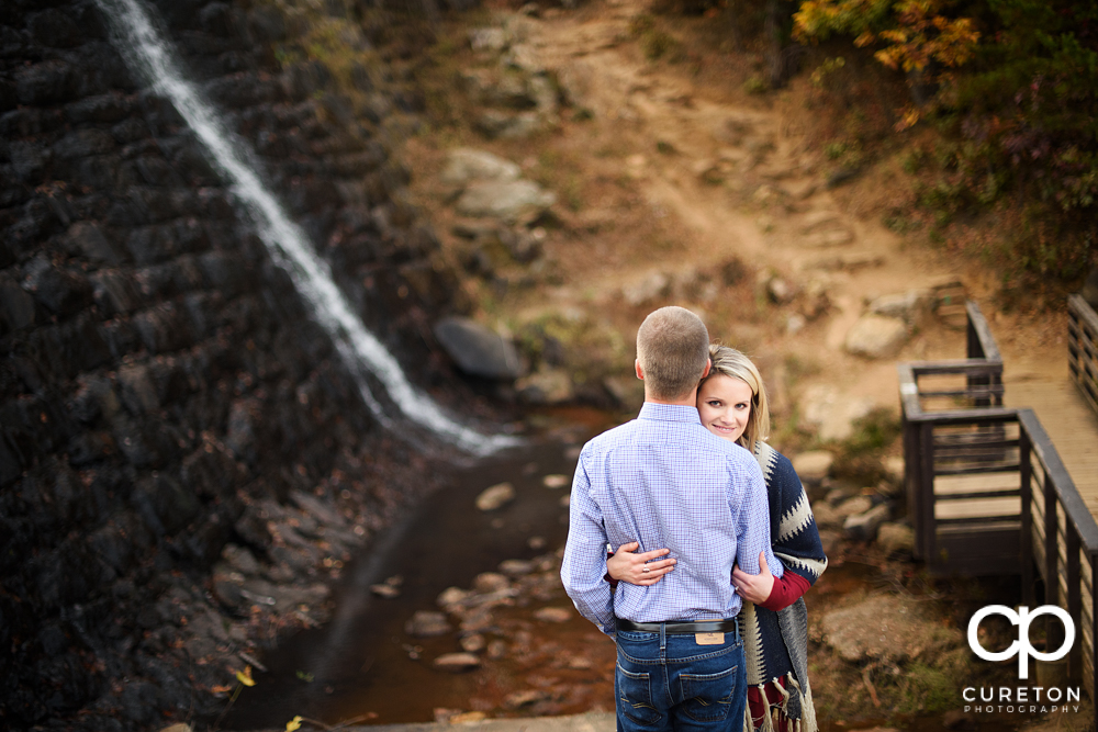 Future bride and groom in front of the falls at Paris mountain.