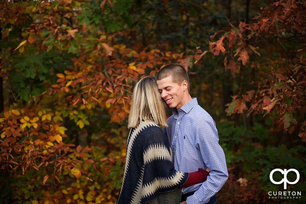 Woman making her fiancé laugh during their engagement session.