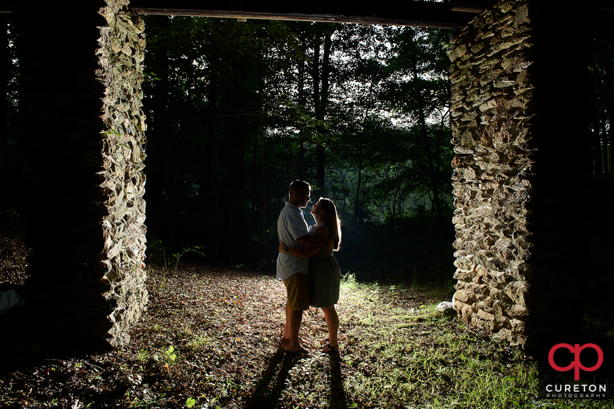Cool shot of an engaged couple in the woods at Paris Mountain State PArk.