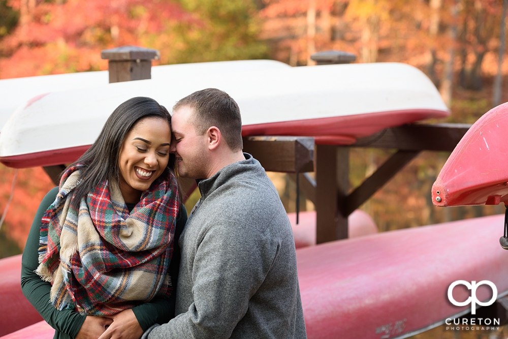 Future bride and groom cuddling during their Paris Mountain State Park Engagement Session in Greenville,SC.