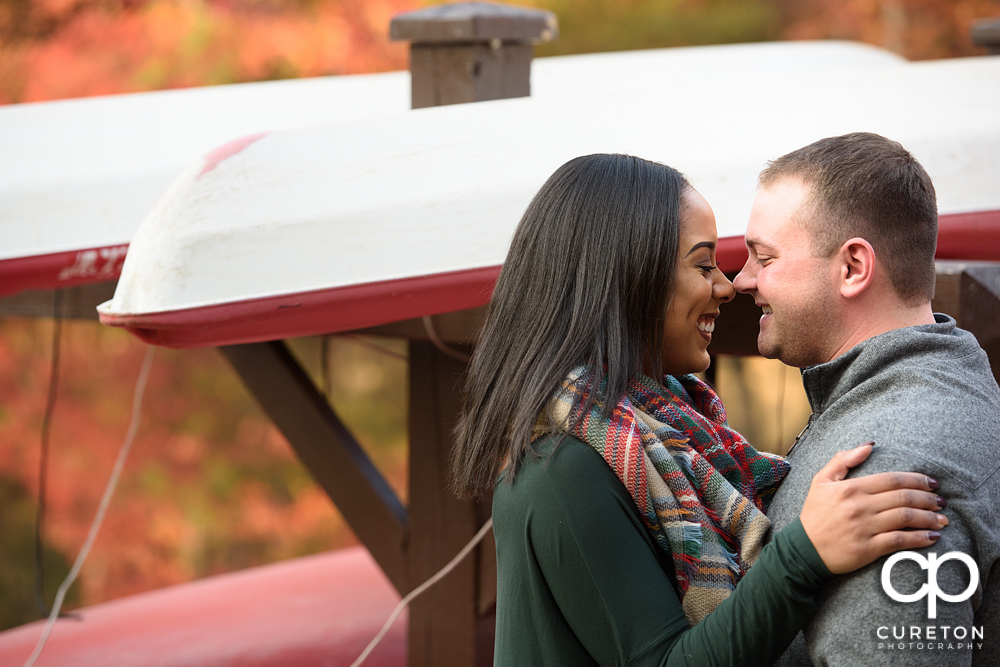 Engaged couple smiling nose to nose during their Paris Mountain State Park Engagement Session in Greenville,SC.