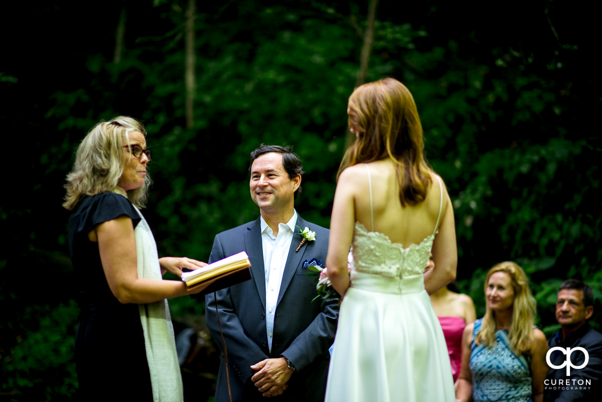 Groom smiling at the wedding officiant.