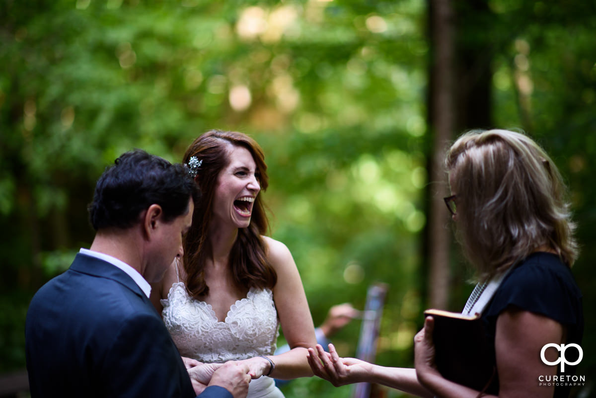 Bride laughing during the wedding ceremony.