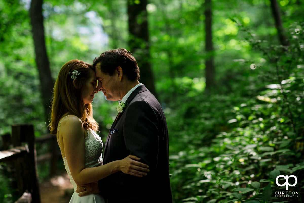 Bride and groom in the forest.