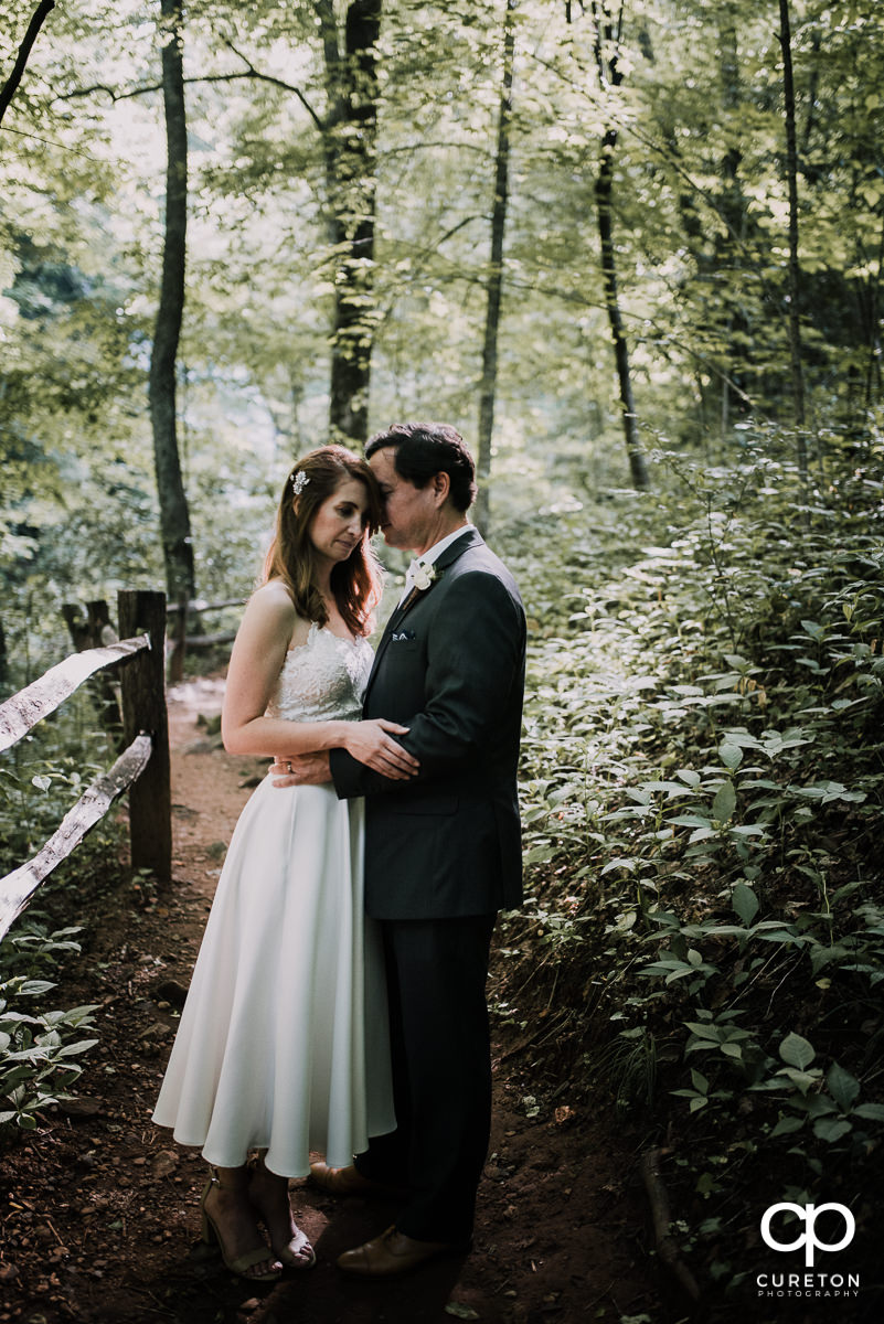 Bride and groom cuddling after their mountain elopement wedding.