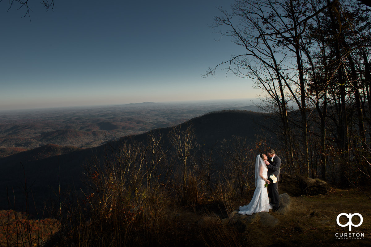 Bride and Groom with a scenic mountain lookout after their Pretty Place Chapel wedding.