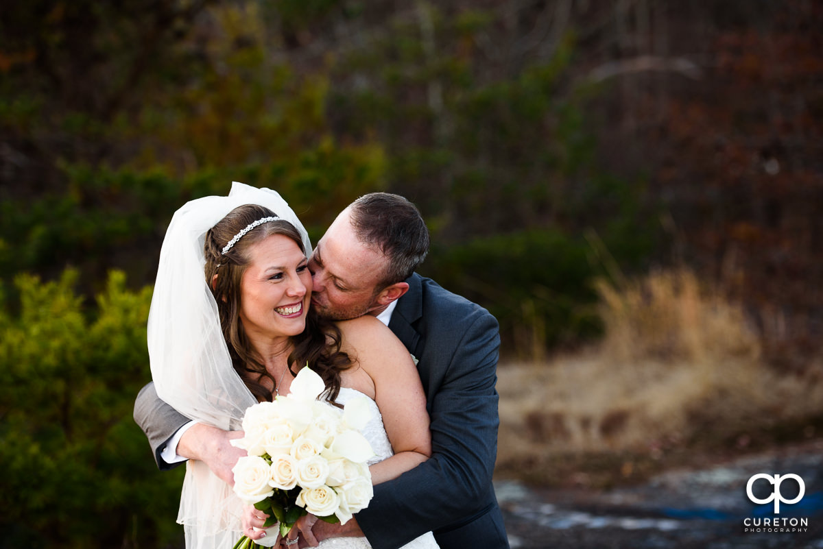 Groom and bride kissing after their ceremony.