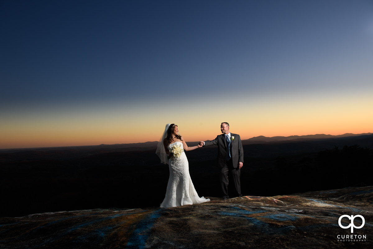 Bride and groom at sunset at Bald Rock in the mountains after their wedding ceremony.