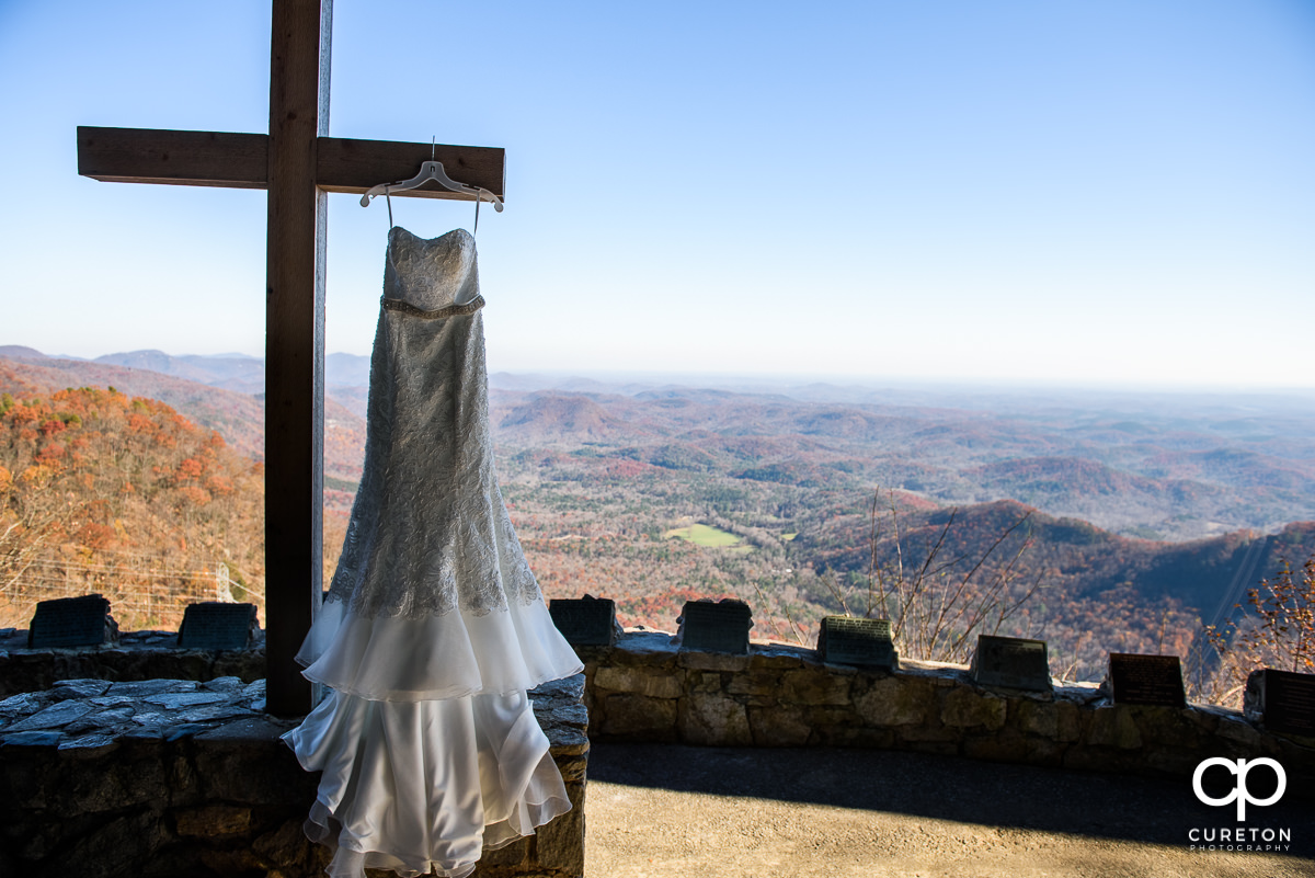 Bride's dress hanging at pretty Place on the cross.
