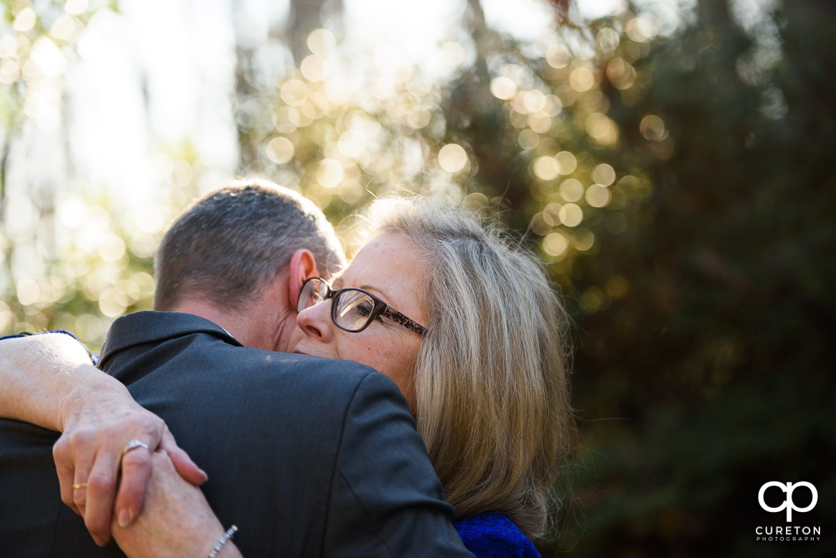 Groom's mom hugging him before the wedding ceremony.