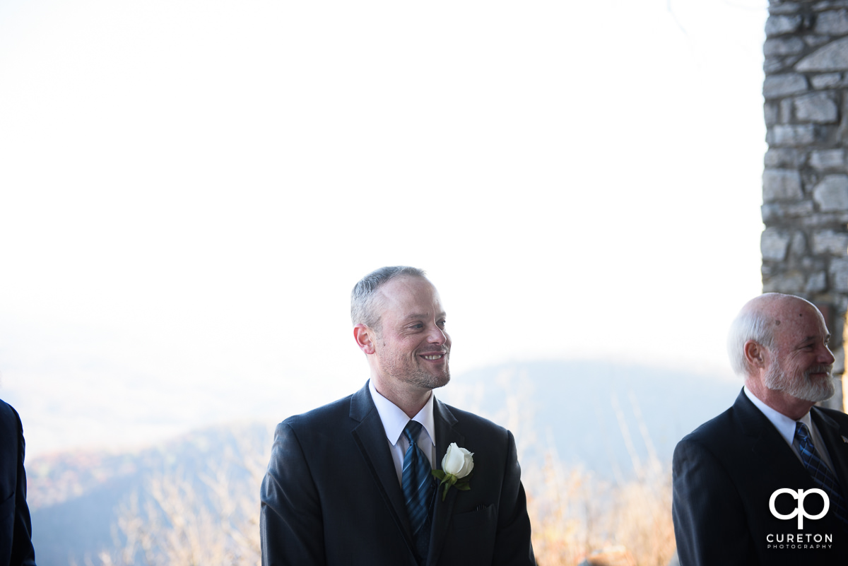 Groom sees his bride walking down the aisle for the first time at Pretty Place.