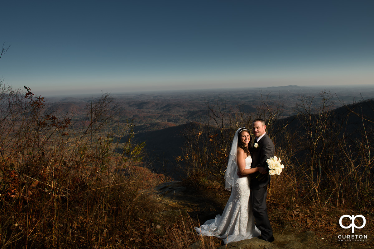 Bride and groom at a scenic lookout at Symmes Chapel.