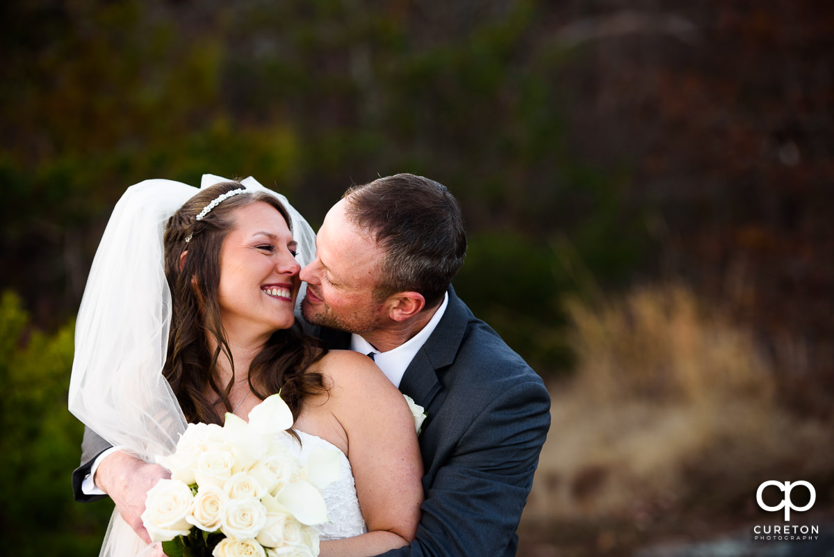Bride and groom smiling at each other.