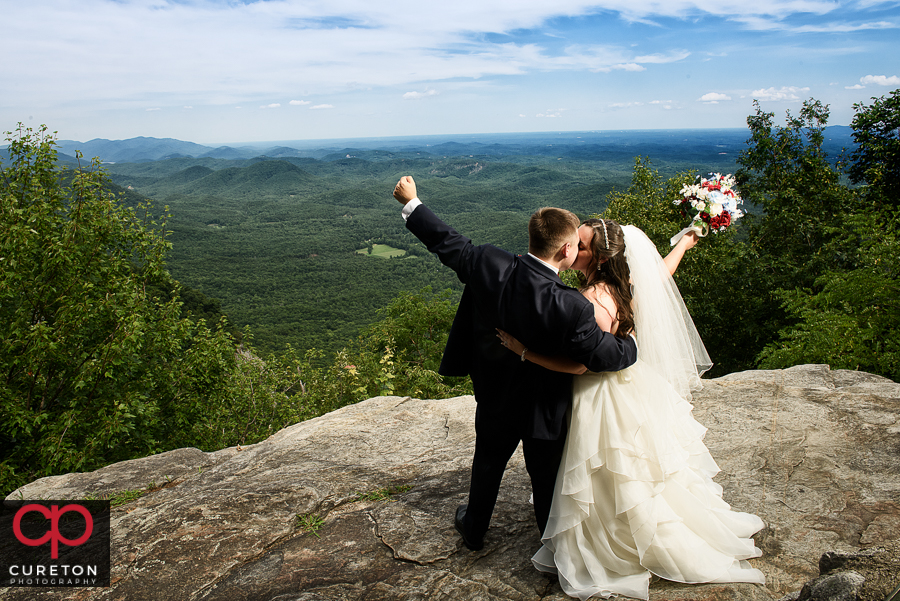 Bride and groom on a cliff after their wedding at Pretty Place.