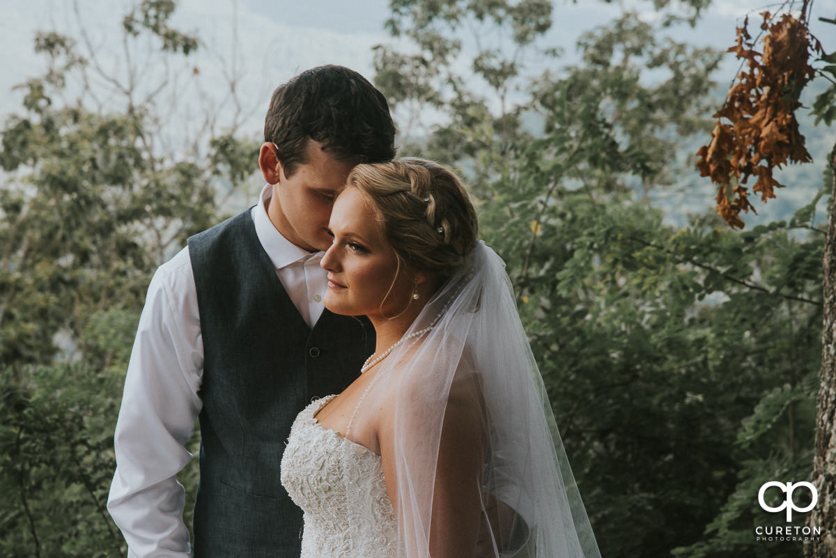 Groom and bride snuggling after the ceremony.