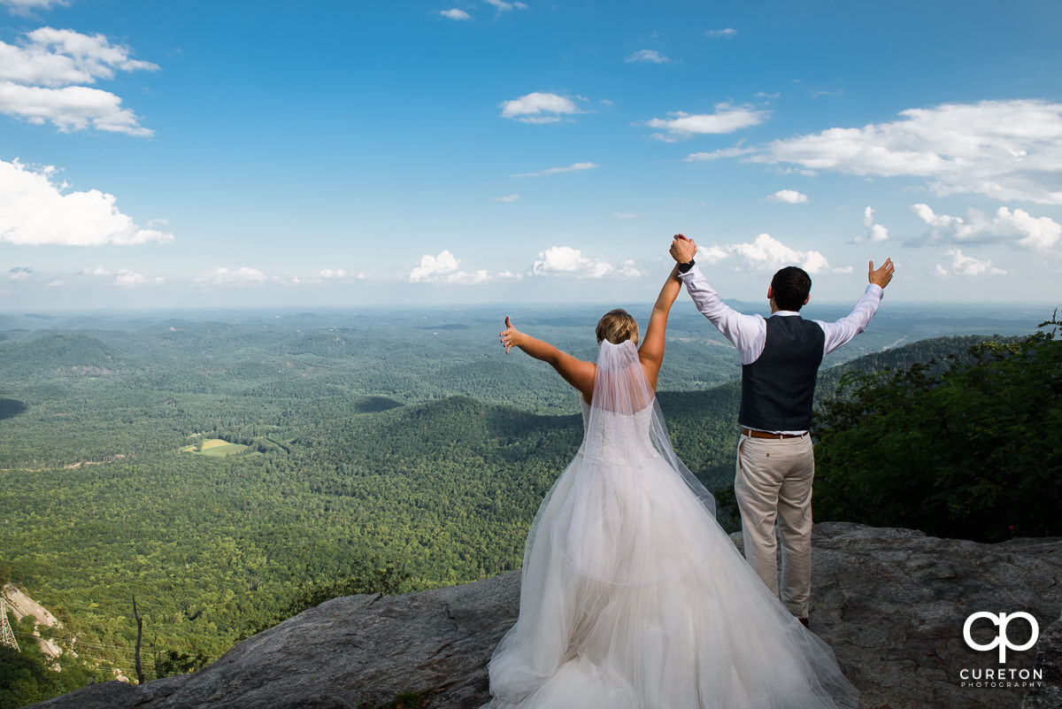 Newlywed couple on the rock at Pretty Place.