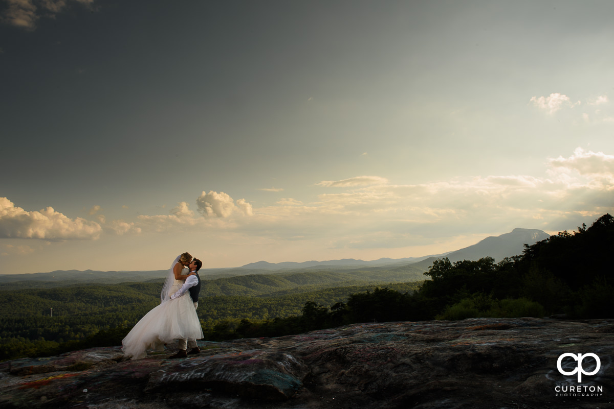 Groom lifting his bride.