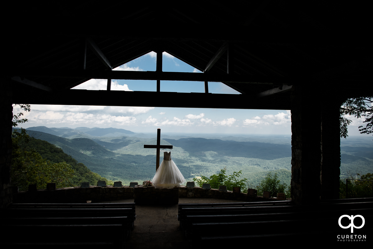 Bride's dress hanging on the cross at Pretty Place.