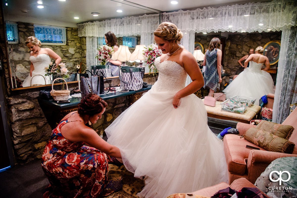 Bride putting on shoes.