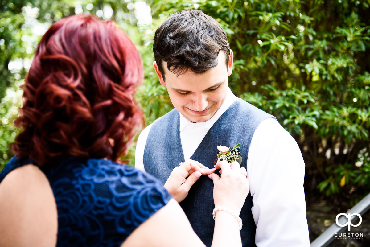 Groom getting his boutonniere on.
