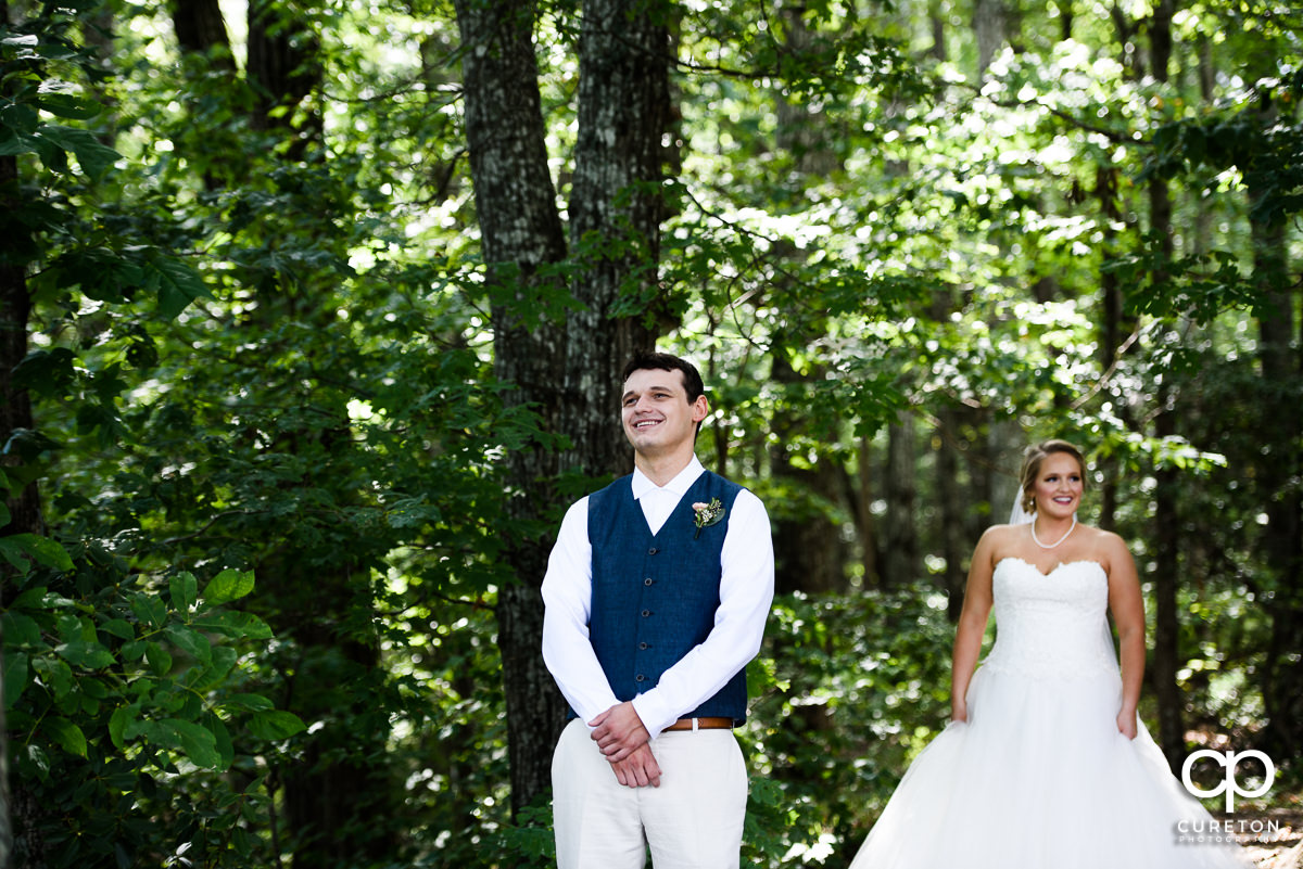 Groom smiling during the first look.