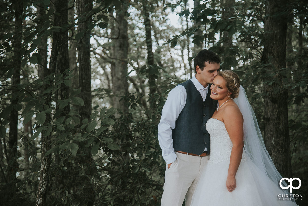 Groom kissing his bride at the first look.