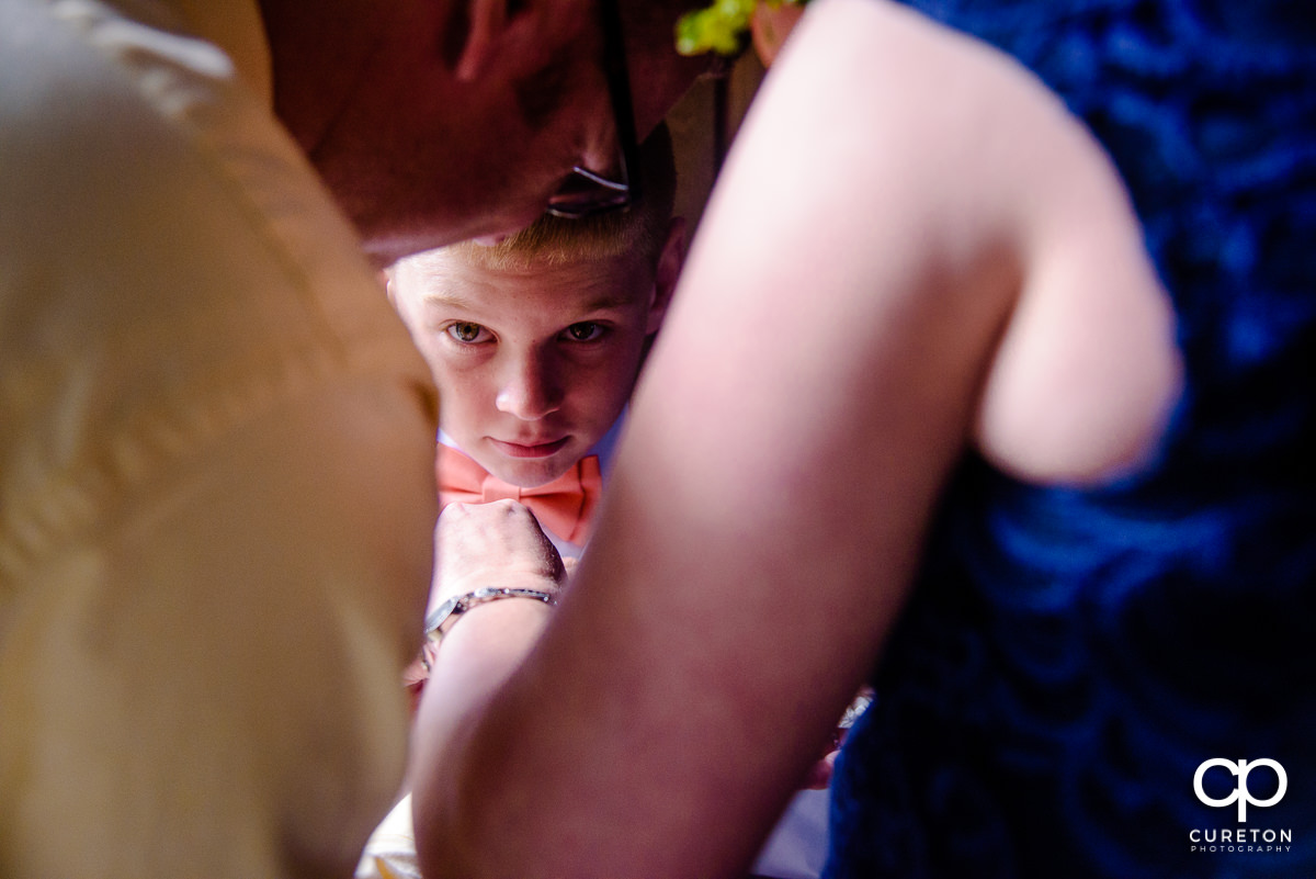 Ring bearer getting his tie put on.