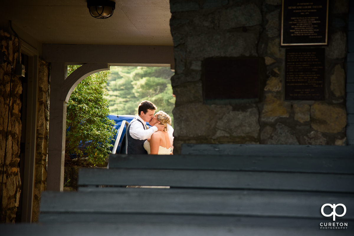 Bride and groom kissing.