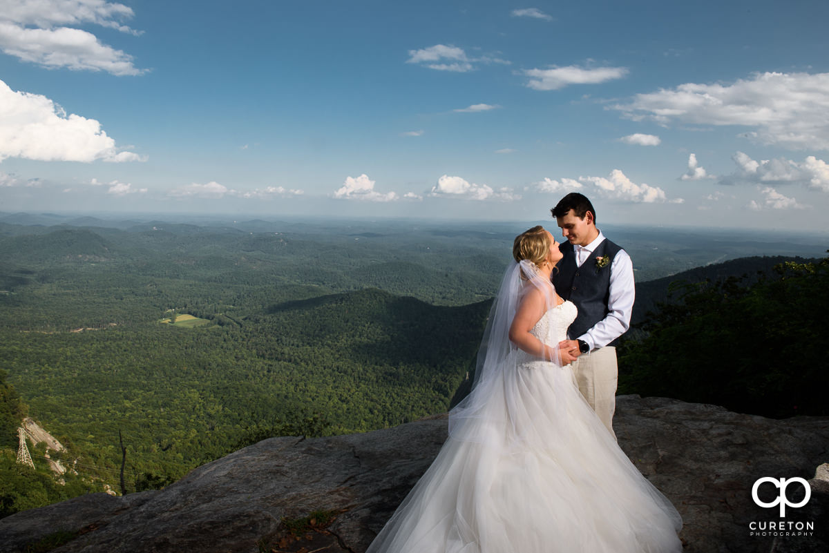 Bride and groom on the rock at Symmes Chapel after their wedding ceremony.