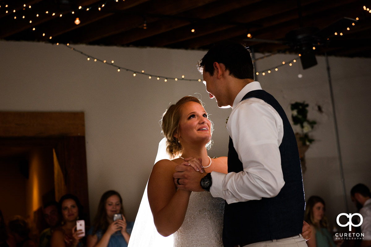 Bride and groom having a first dance at Artisan Traders during their wedding reception.