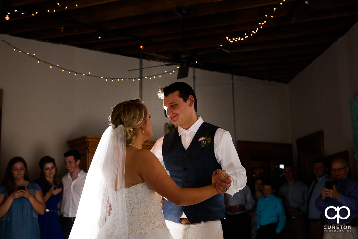 Bride and groom having a first dance at Artisan Traders during their wedding reception.