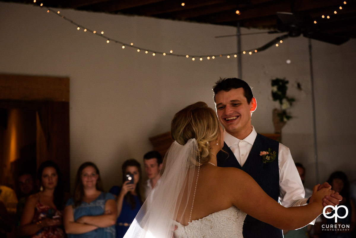 Bride and groom having a first dance at Artisan Traders during their wedding reception.