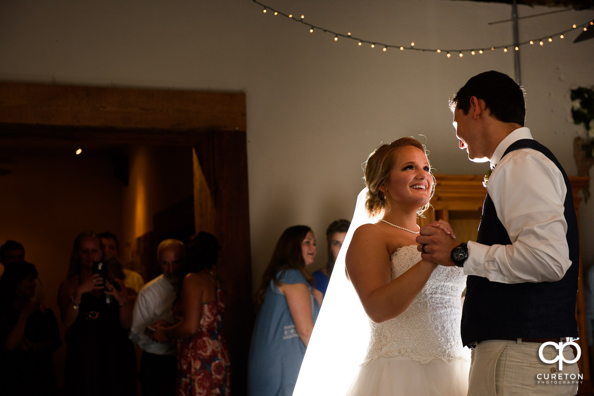 Bride and groom having a first dance at Artisan Traders during their wedding reception.