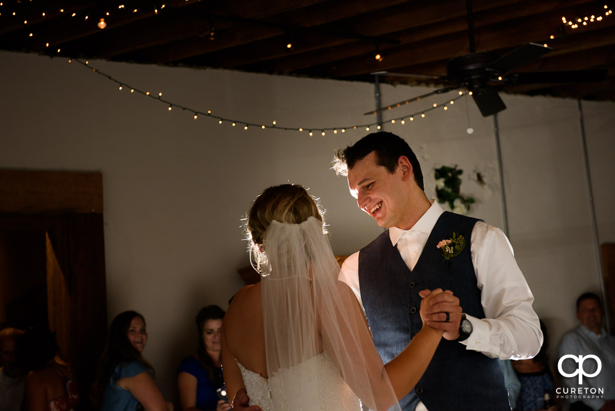 Bride and groom having a first dance at Artisan Traders during their wedding reception.