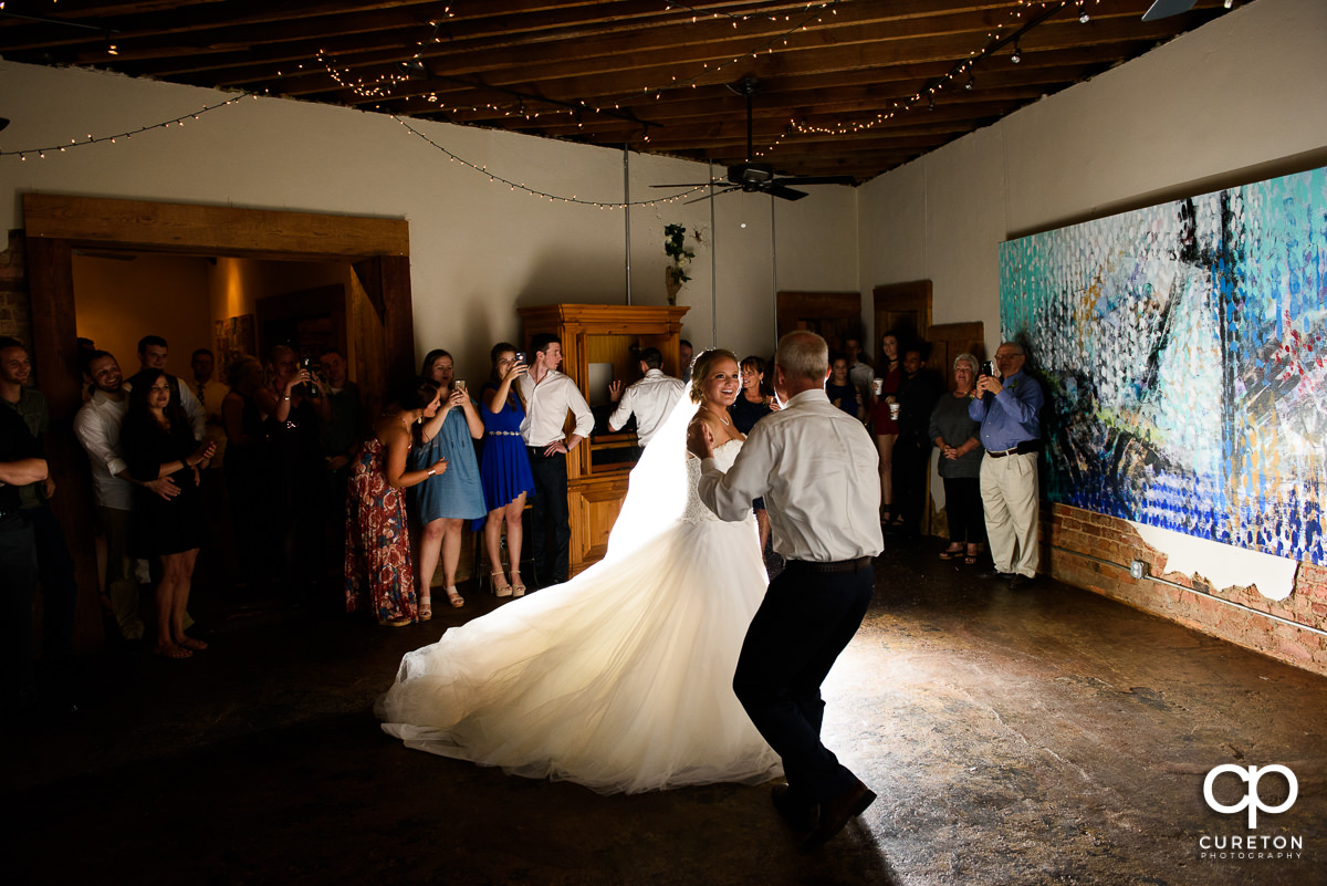 Bride and father dance at Artisan Traders.