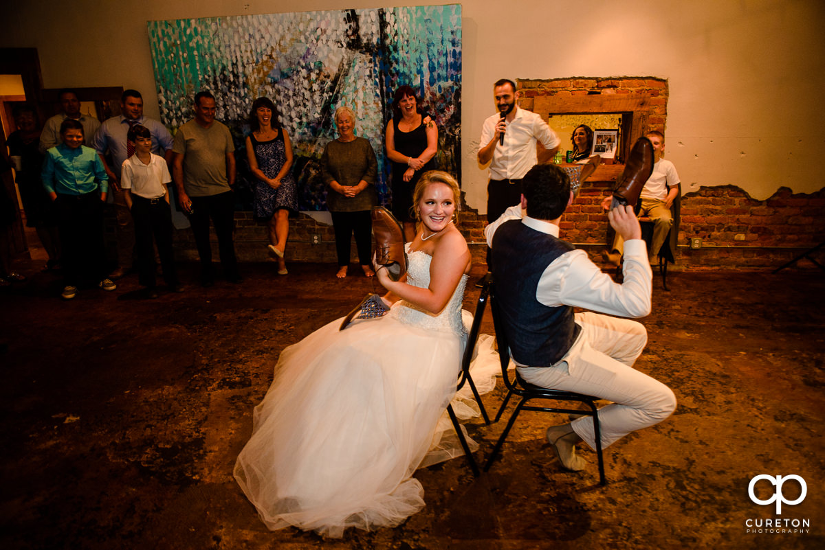 Bride and groom playing the shoe game.