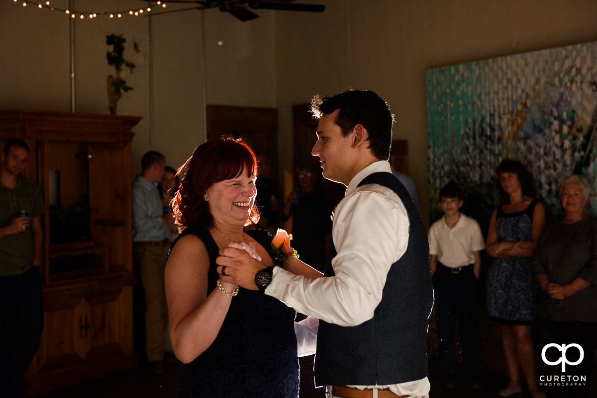 Groom and mother dance at the reception.
