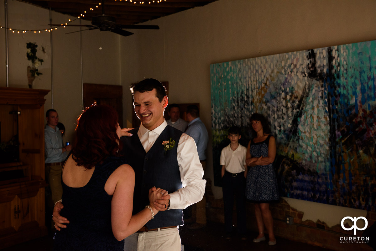 Groom and mother dance at the reception.