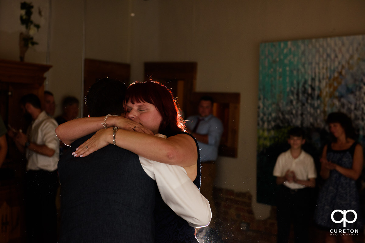 Groom and mother dance at the reception.
