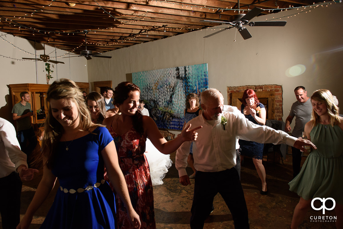 Wedding reception guests dancing at Artisan Traders.