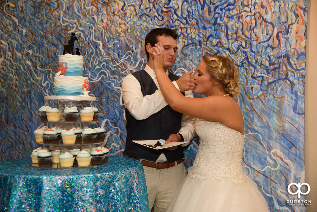Bride and groom cutting the cake.