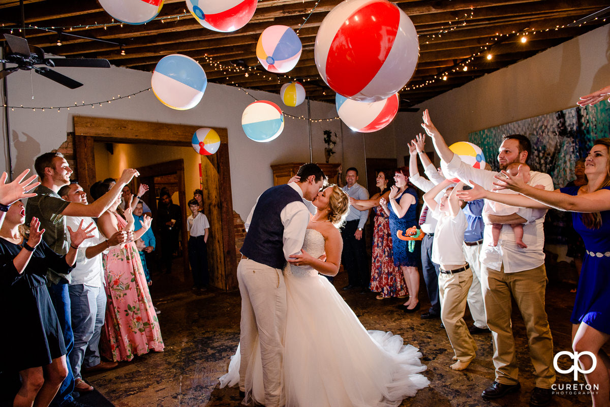 Wedding reception grand exit with beach balls in Greenville,SC at Artisan Traders.