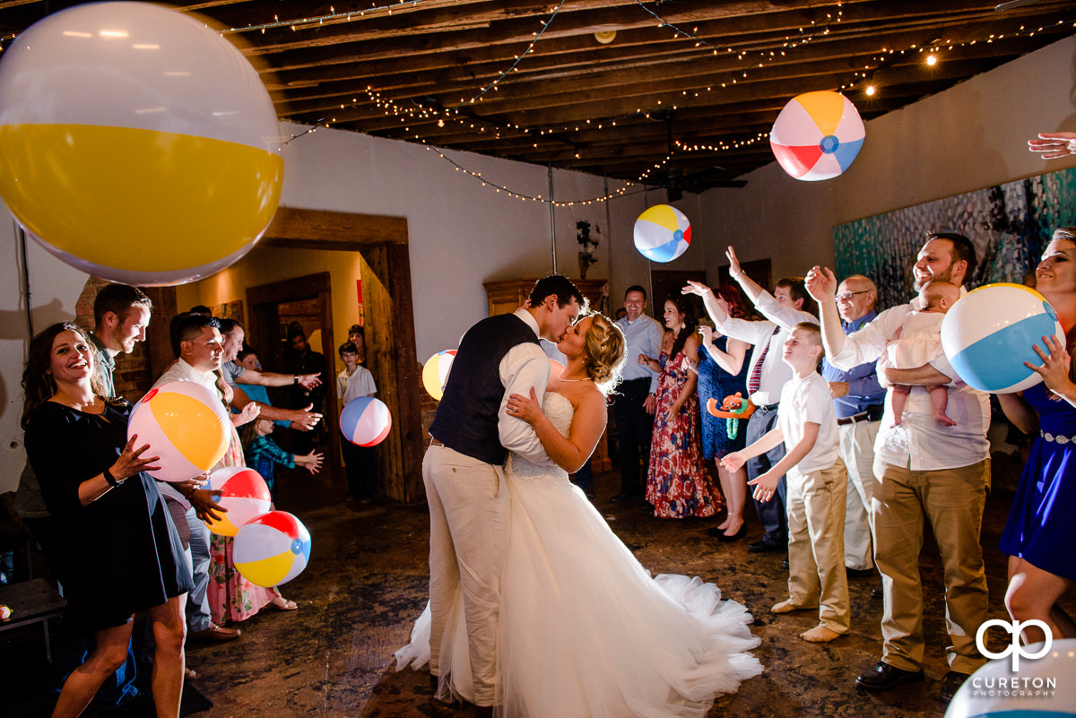 Wedding reception grand exit with beach balls in Greenville,SC at Artisan Traders.