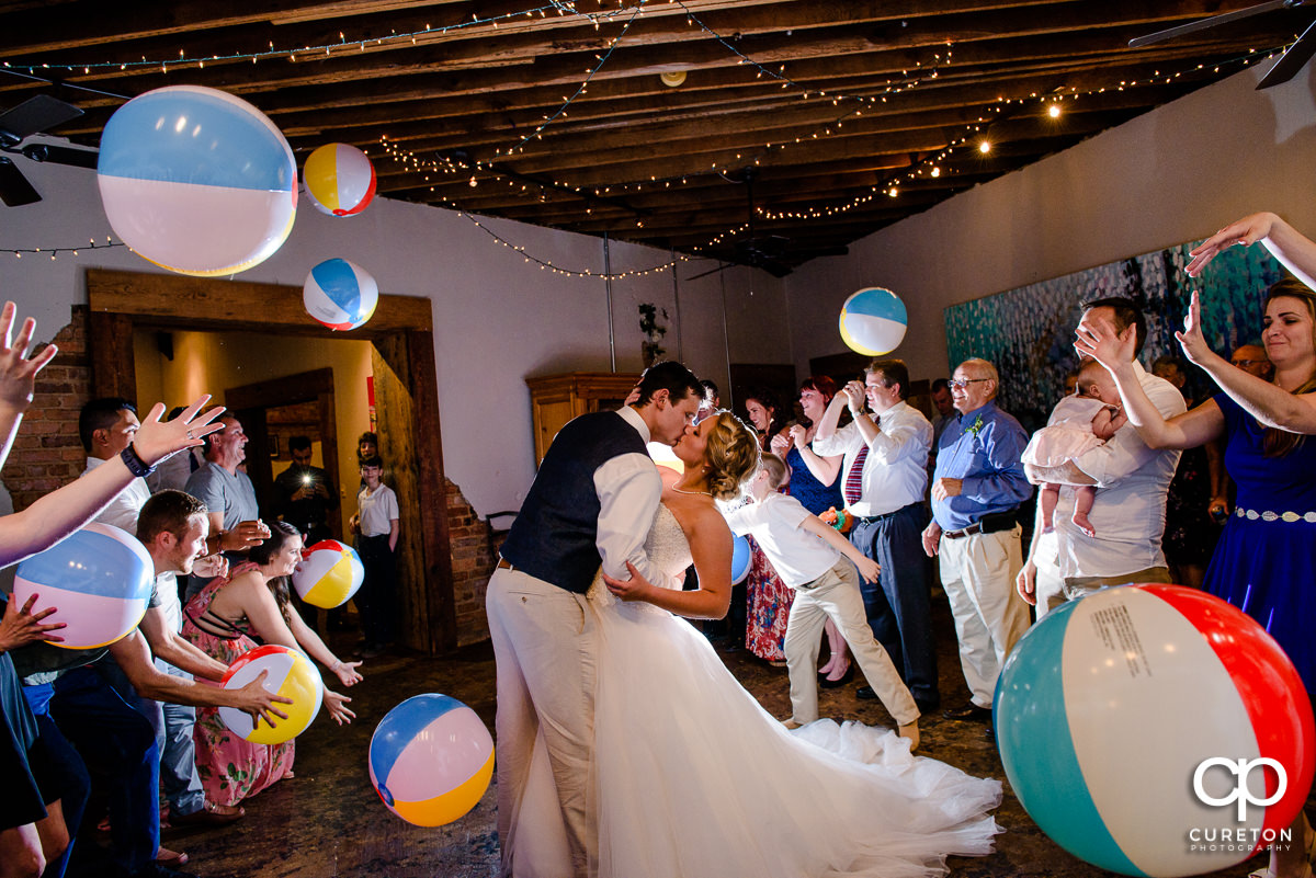 Wedding reception grand exit with beach balls in Greenville,SC at Artisan Traders.