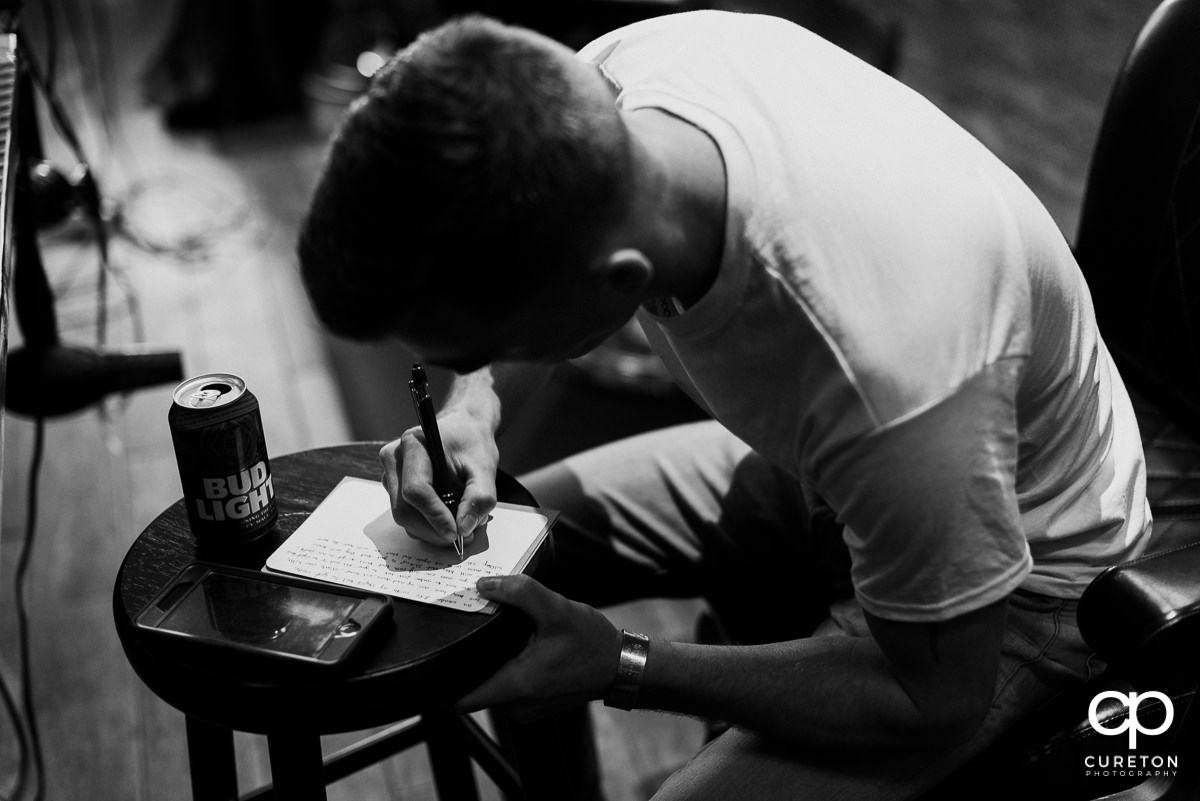 Groom writing a letter to his bride.