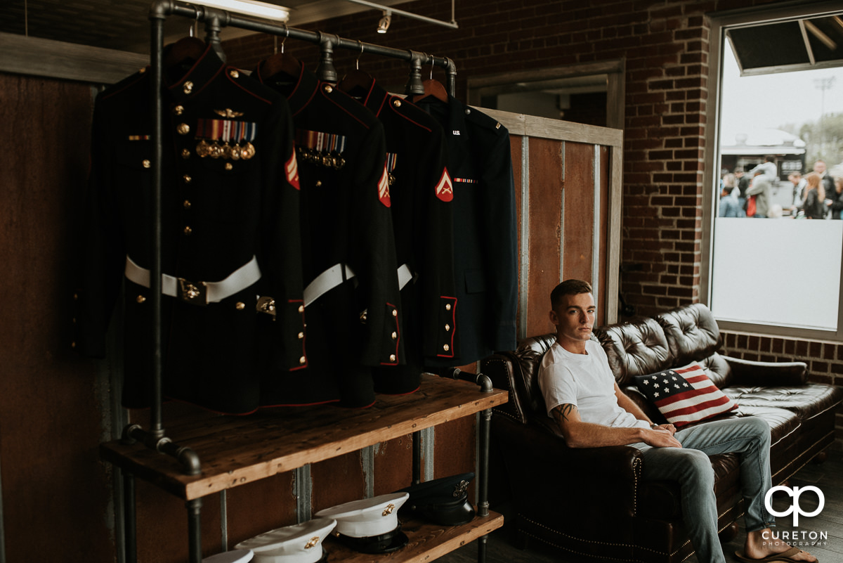 Groom sitting at the barber shop before his wedding before putting on his Marine dress uniform.
